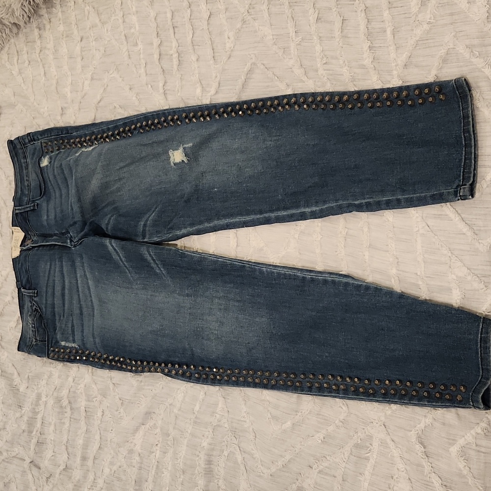 Medium wash Rachel Roy jeans size 32 with studded detail down both sides.